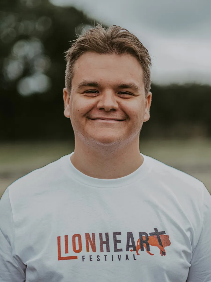 Joe Shurmer, smiling, in a Lionheart Festival t-shirt
